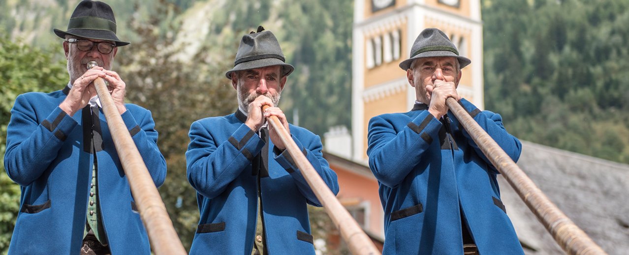 Alpenhorn players in folk costume