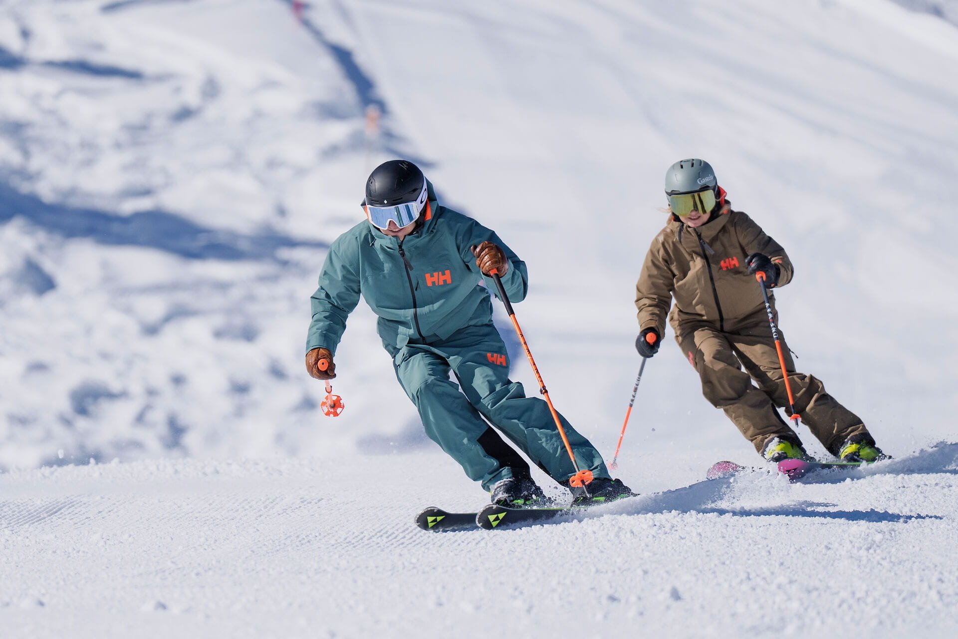 Skifahrer und Skifahrerin beim Carven auf der Schlossalm im Gasteinertal auf frisch präparierter Piste